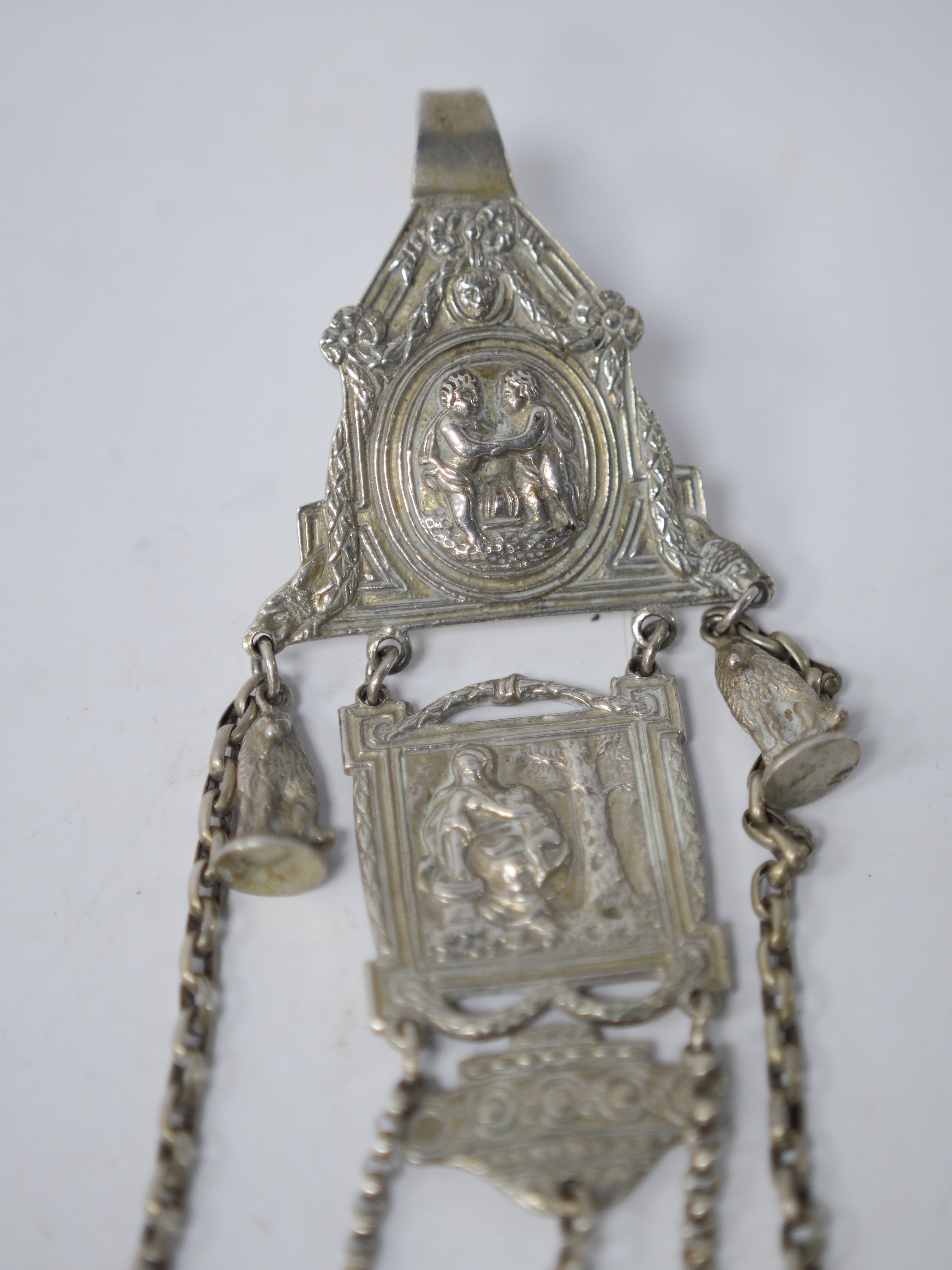 A late 19th/early 20th century continental white metal chatelaine, hung with six assorted accoutrements including a small silver box, a George III silver oval snuff box, a pen knife, compass and cross pendant. overall ap